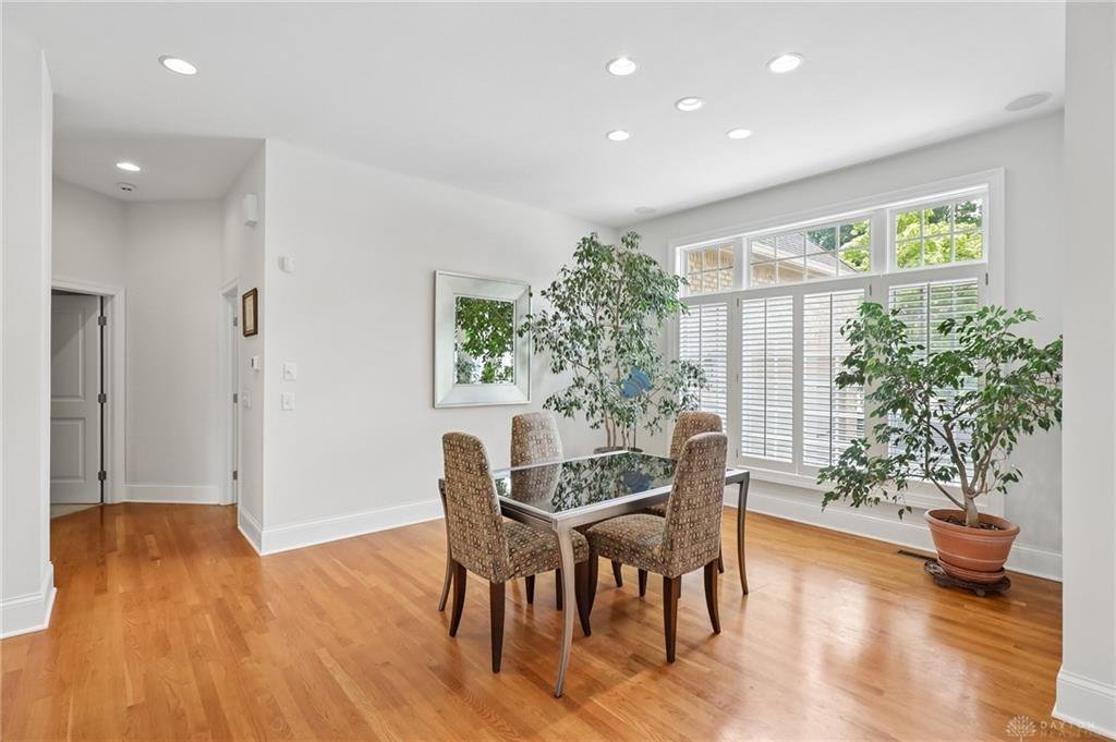 Finished basement recreation room with a wet bar and daylight windows