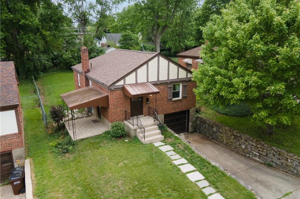 Covered patio and partially fenced backyard