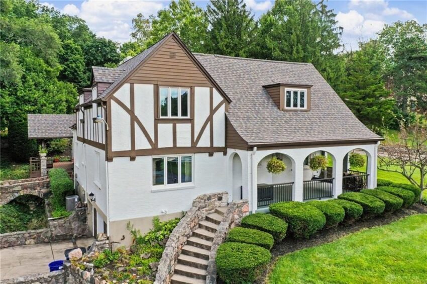 Living room of the Tudor Revival at 3504 Deweese Parkway with a wood-burning fireplace