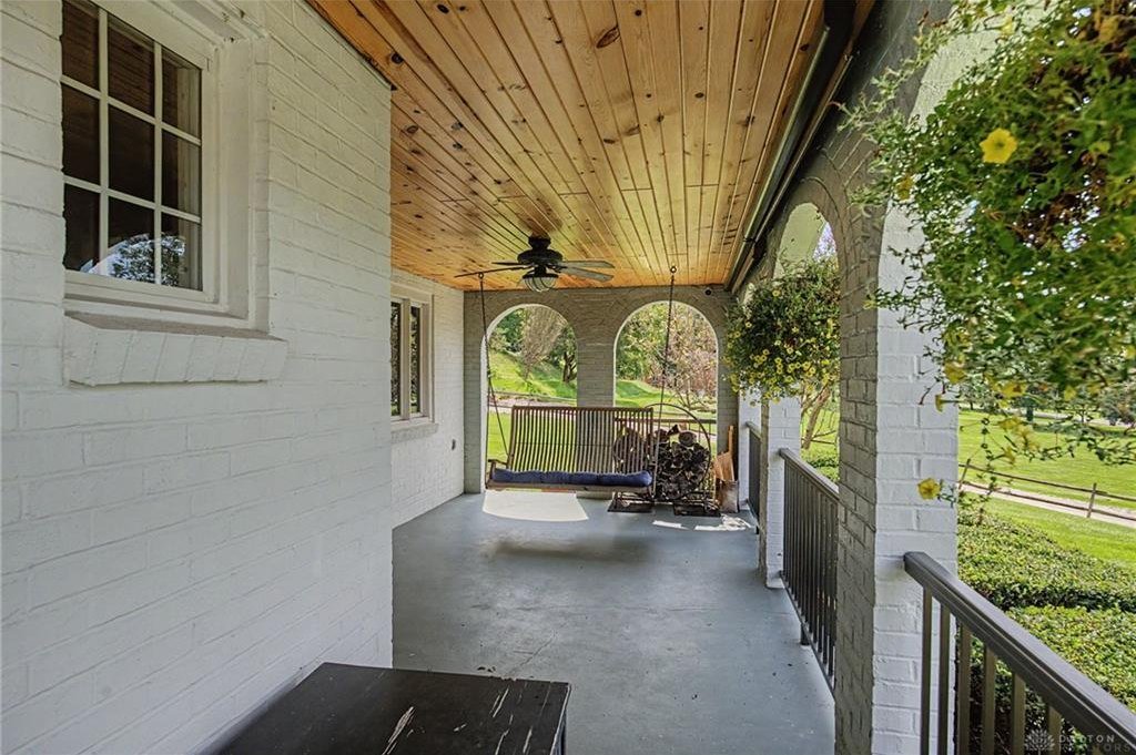 Arched covered porch at the entrance of the Tudor Revival on Deweese Parkway