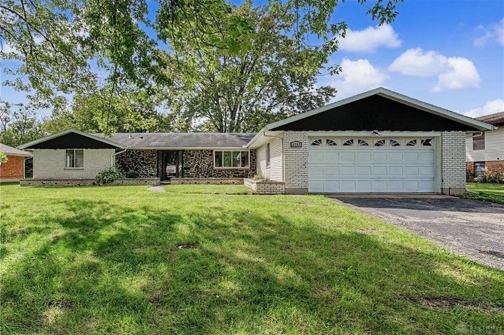 Front exterior of the brick ranch at 4703 Stonehedge Street in Trotwood