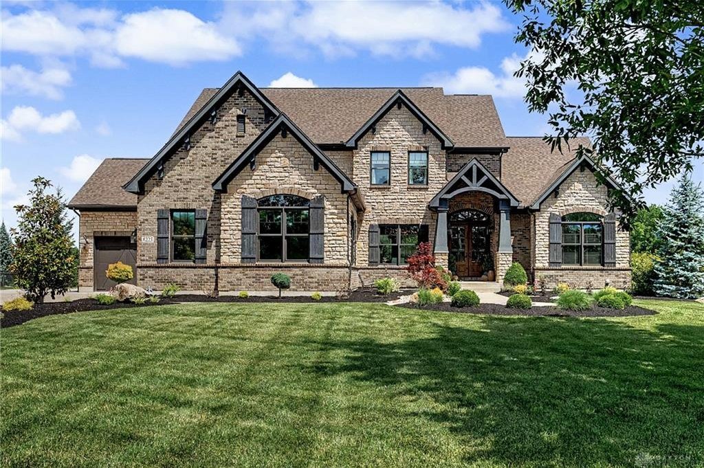 Front exterior of 8223 Turning Leaf Crossing in Clearcreek Township with landscaped entry